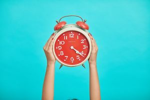 red clock with blue background