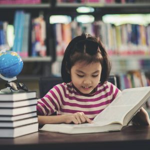 young girl reading a book